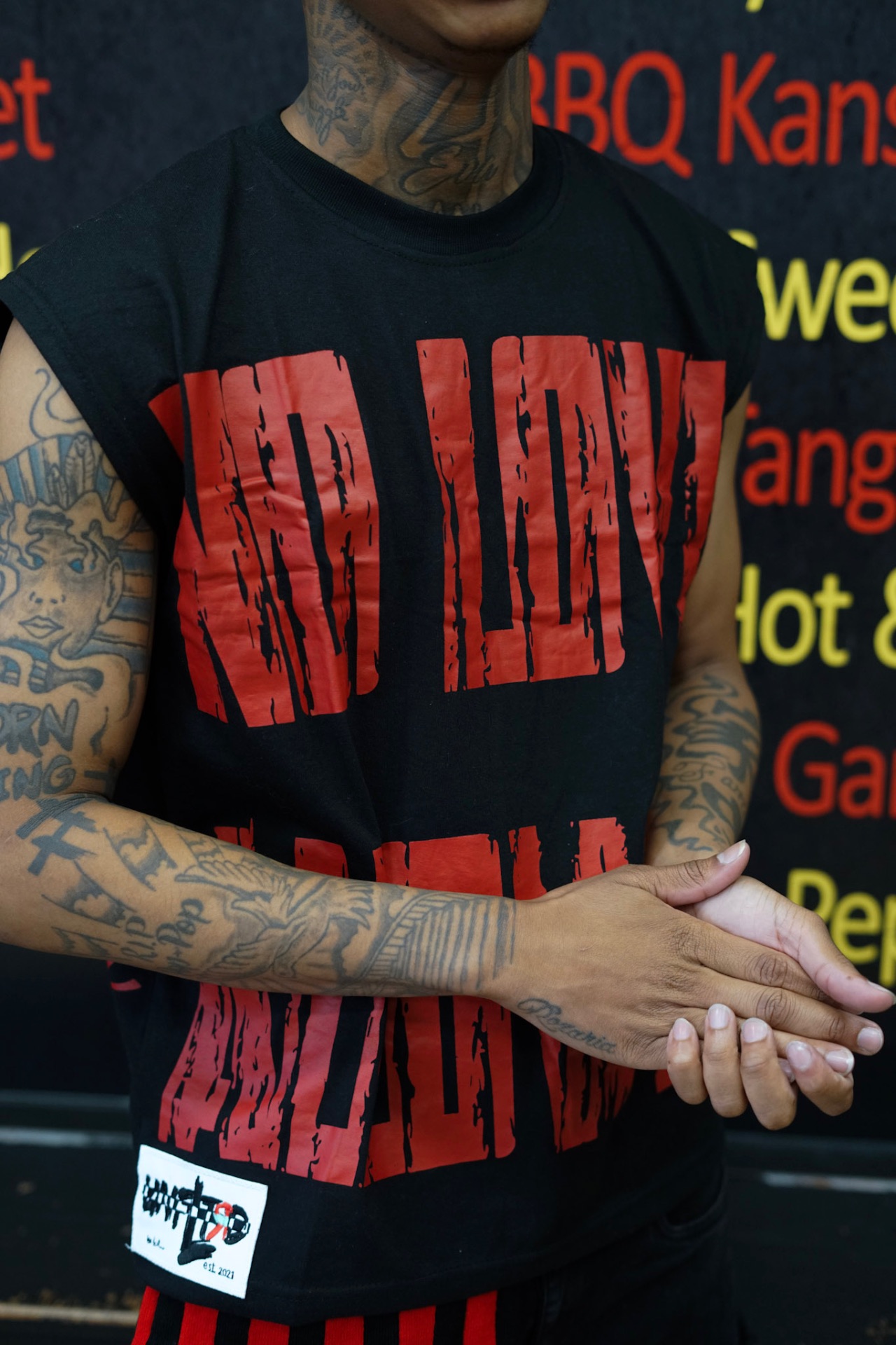 UNFLTRD model wearing the red logo tee